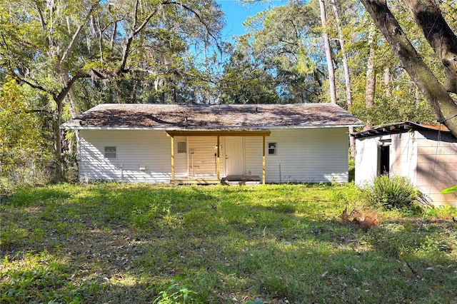 view of outbuilding with a yard