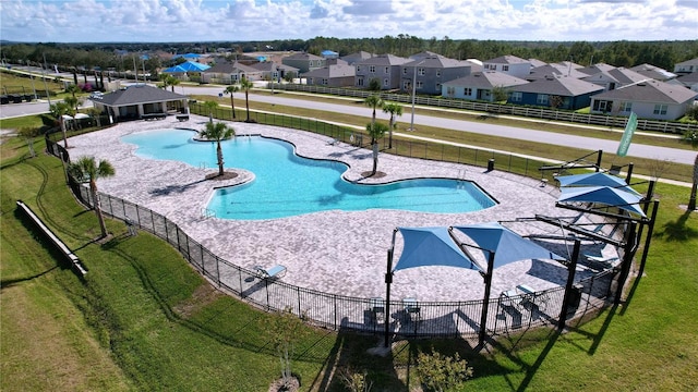 view of pool with a lawn