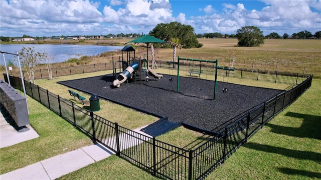 view of playground featuring a yard and a water view