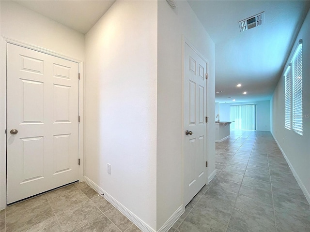 hallway featuring light tile patterned floors