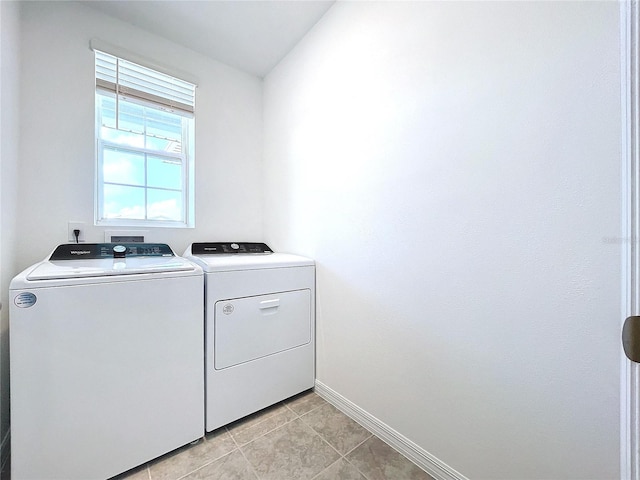 washroom with independent washer and dryer and light tile patterned floors