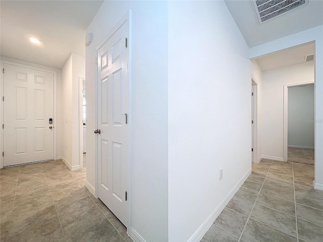 corridor featuring light tile patterned floors