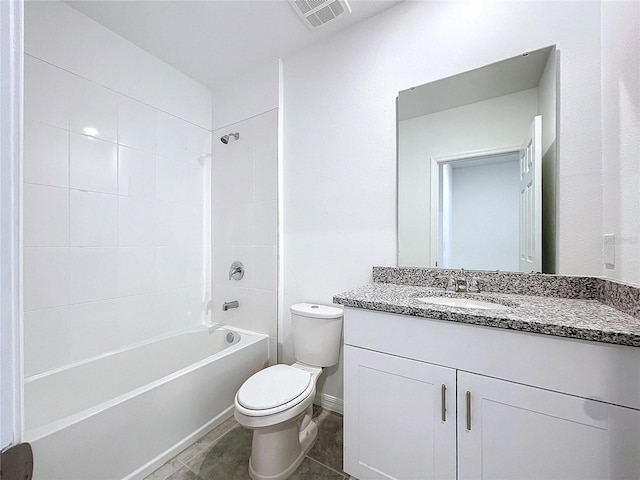 full bathroom with tile patterned floors, vanity, tiled shower / bath combo, and toilet