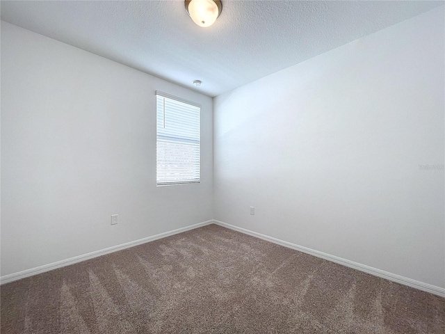 carpeted spare room featuring a textured ceiling