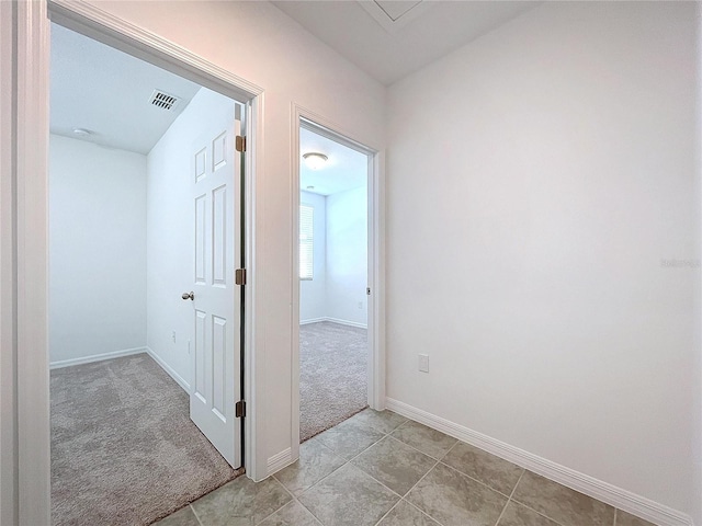 hallway with light colored carpet