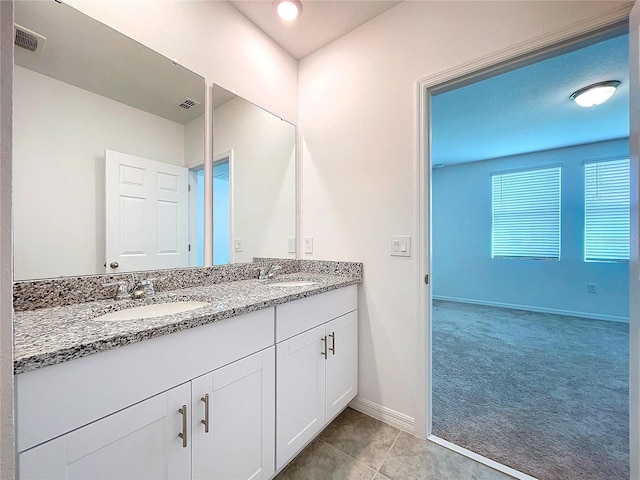 bathroom with tile patterned flooring and vanity