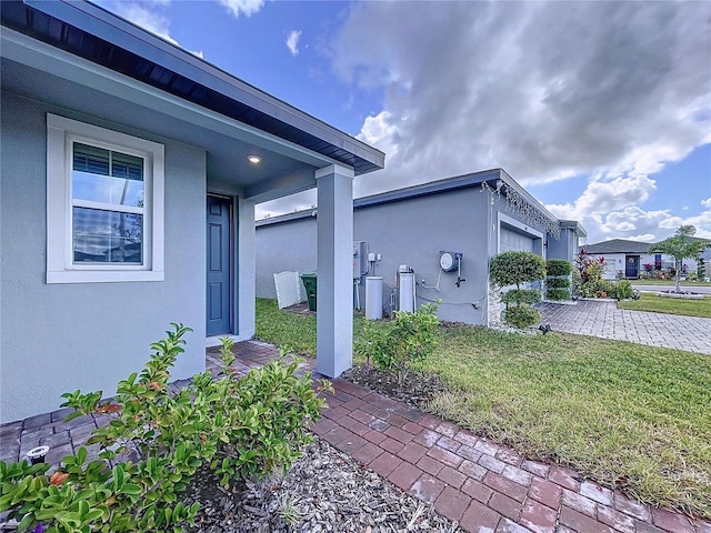 view of side of home with a lawn and a garage