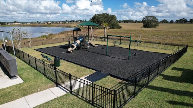 view of playground with a water view and a lawn