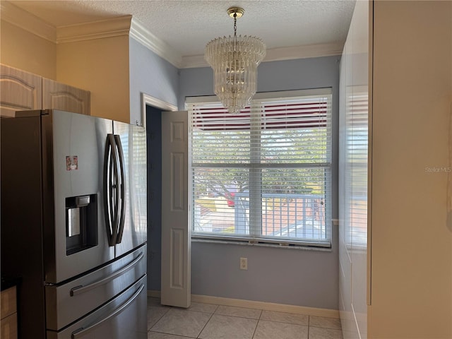 kitchen featuring light tile patterned flooring, an inviting chandelier, a healthy amount of sunlight, and stainless steel fridge with ice dispenser