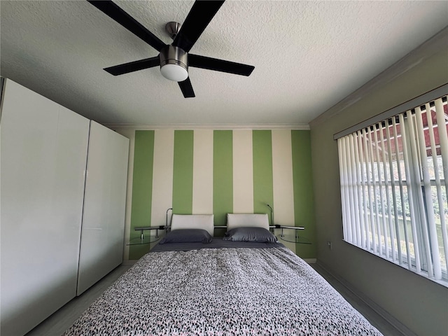 bedroom featuring a textured ceiling and ceiling fan