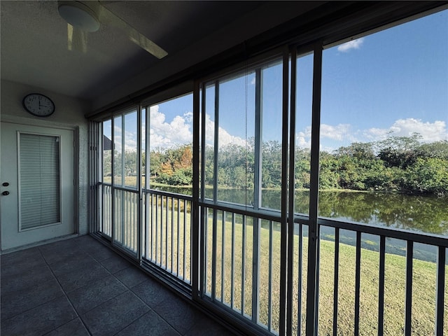 unfurnished sunroom featuring a water view