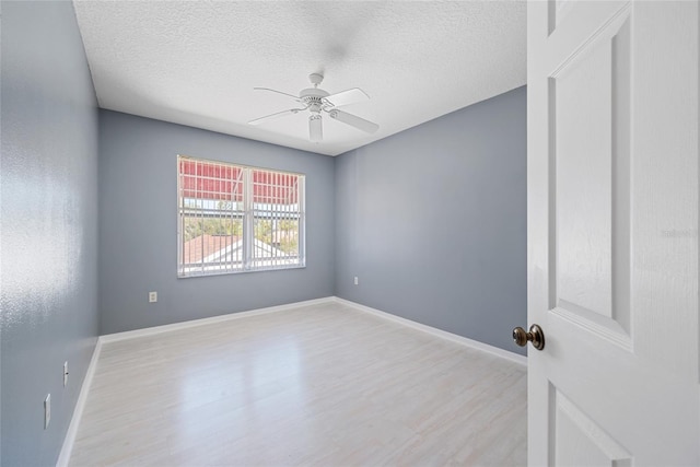 empty room featuring ceiling fan, a textured ceiling, and light hardwood / wood-style floors