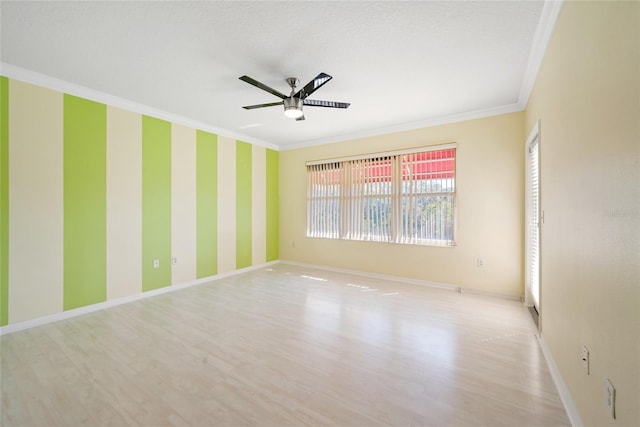 spare room featuring crown molding, ceiling fan, and light hardwood / wood-style floors