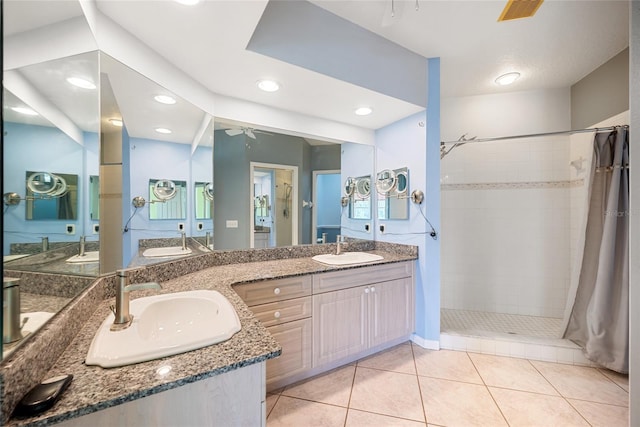 bathroom featuring vanity, tile patterned floors, ceiling fan, and walk in shower