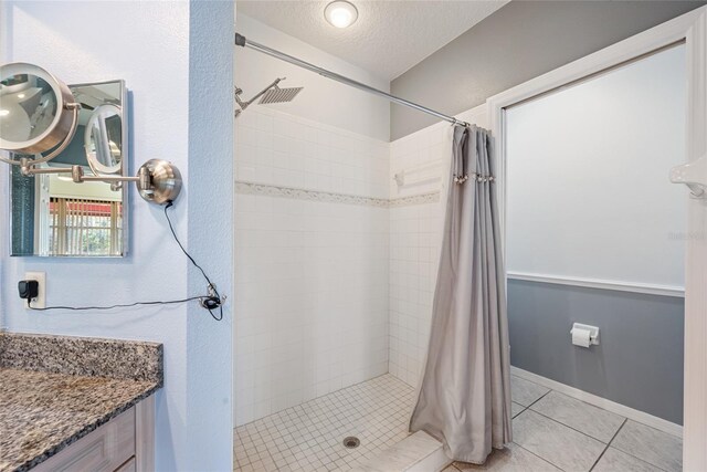 bathroom featuring tile patterned floors, a textured ceiling, and walk in shower