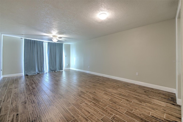 spare room featuring ceiling fan, wood-type flooring, and a textured ceiling