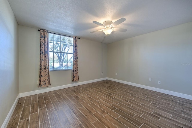 empty room with a textured ceiling, ceiling fan, and dark hardwood / wood-style floors