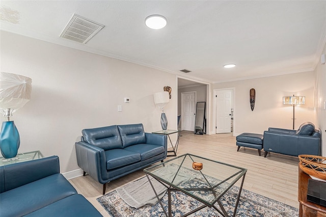 living room featuring light hardwood / wood-style floors and crown molding