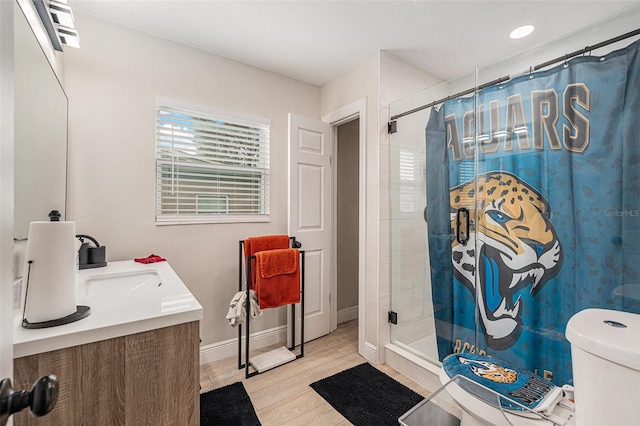 bathroom with a shower with curtain, vanity, and toilet