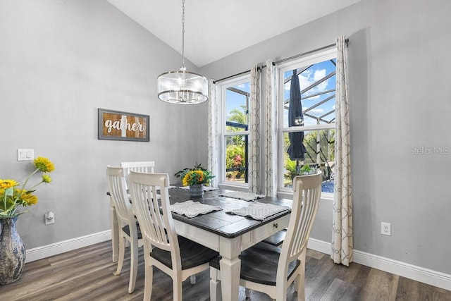 dining space featuring an inviting chandelier, dark wood-type flooring, and vaulted ceiling