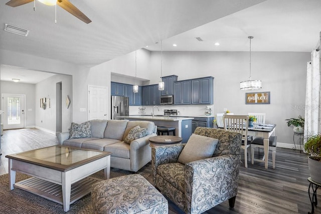 living room with dark hardwood / wood-style flooring, high vaulted ceiling, ceiling fan, and sink