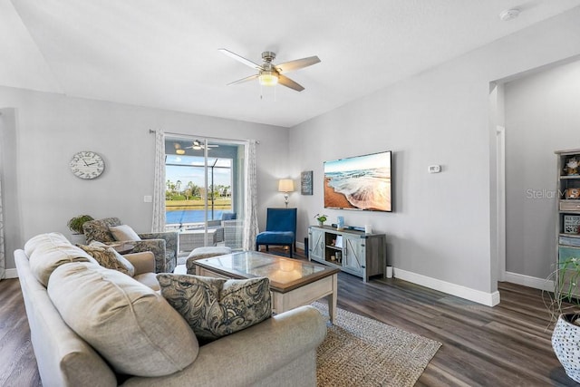 living room featuring ceiling fan and dark wood-type flooring