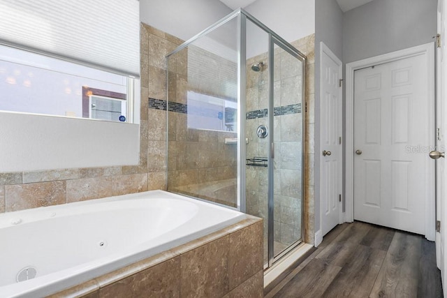 bathroom featuring separate shower and tub and wood-type flooring