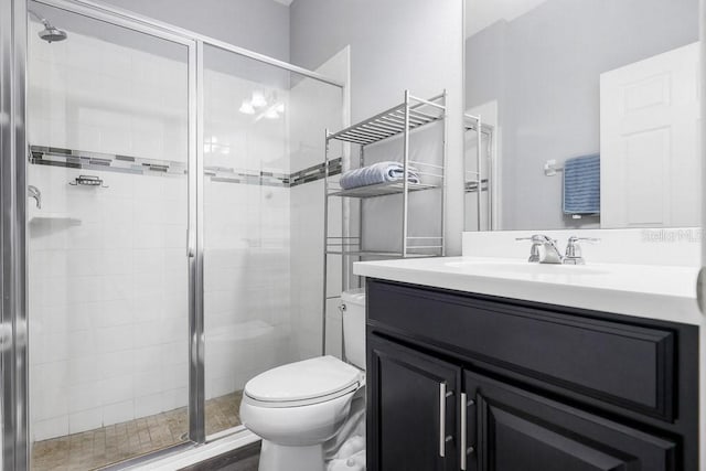 bathroom with vanity, toilet, and an enclosed shower