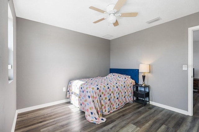 bedroom with dark hardwood / wood-style flooring and ceiling fan