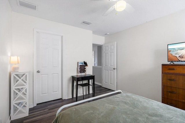 bedroom with ceiling fan and dark wood-type flooring