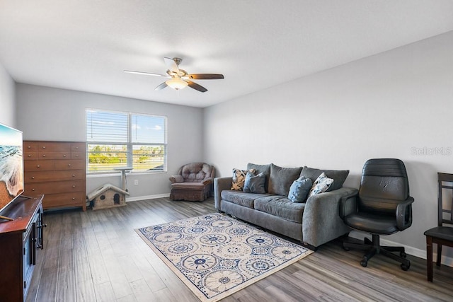 living room featuring hardwood / wood-style floors and ceiling fan