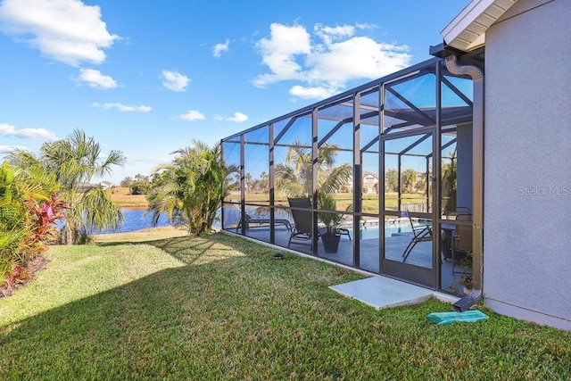 view of yard with a lanai, a patio area, and a water view