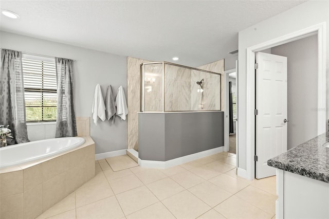 bathroom with vanity, shower with separate bathtub, a textured ceiling, and tile patterned flooring