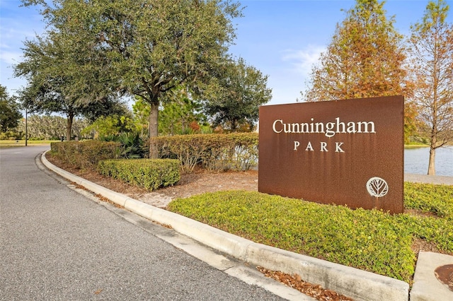 community / neighborhood sign with a water view