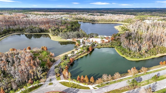 birds eye view of property featuring a wooded view and a water view