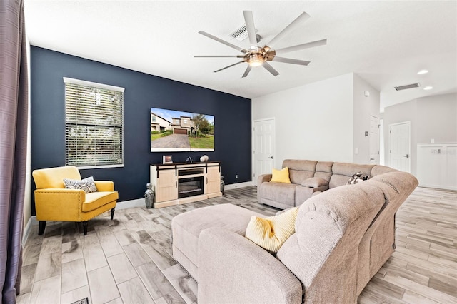 living room with light hardwood / wood-style flooring and ceiling fan