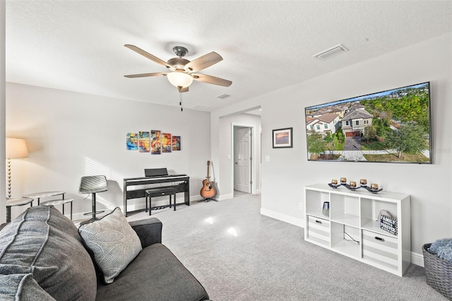 living room with ceiling fan and a textured ceiling