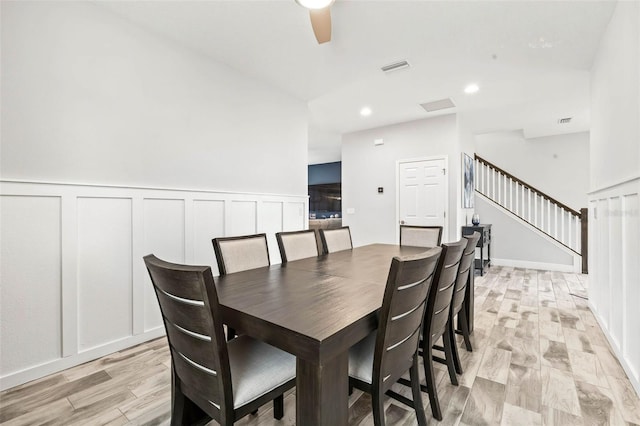 dining space with visible vents, stairway, light wood-type flooring, recessed lighting, and a decorative wall