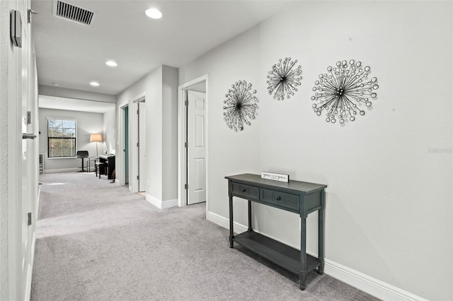 hall featuring recessed lighting, visible vents, carpet floors, and baseboards