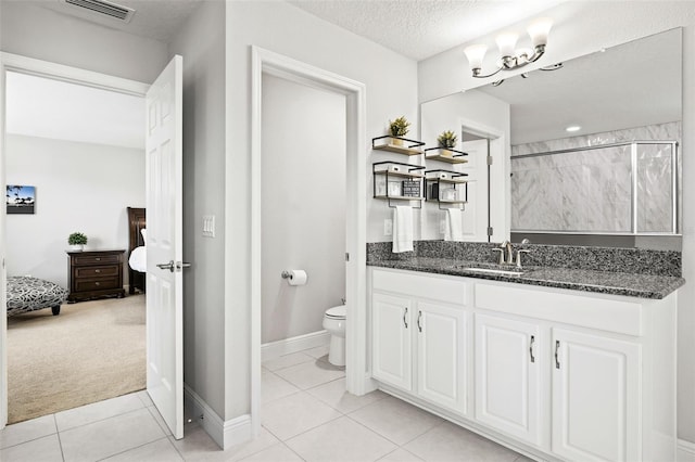 bathroom with visible vents, toilet, ensuite bathroom, tile patterned floors, and a textured ceiling