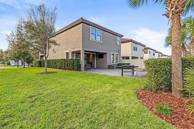 rear view of house featuring a patio, fence, a yard, stucco siding, and central air condition unit