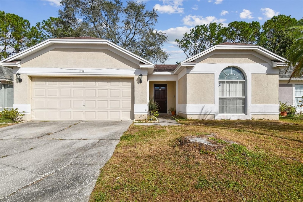 view of front facade featuring a front lawn and a garage