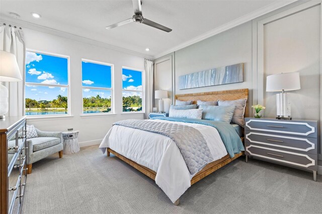 bedroom featuring ceiling fan, crown molding, and carpet