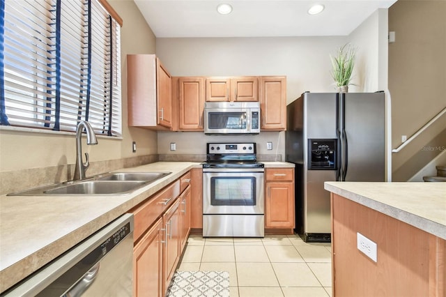 kitchen featuring sink, light tile patterned floors, and appliances with stainless steel finishes