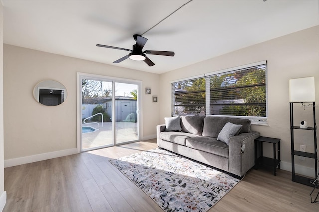 living room featuring ceiling fan and light hardwood / wood-style floors