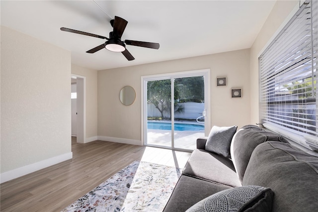 living room with ceiling fan, a healthy amount of sunlight, and light hardwood / wood-style floors