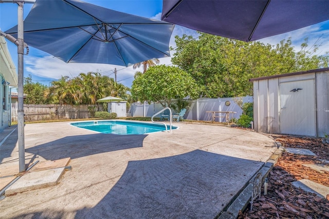 view of swimming pool with a patio and a storage unit