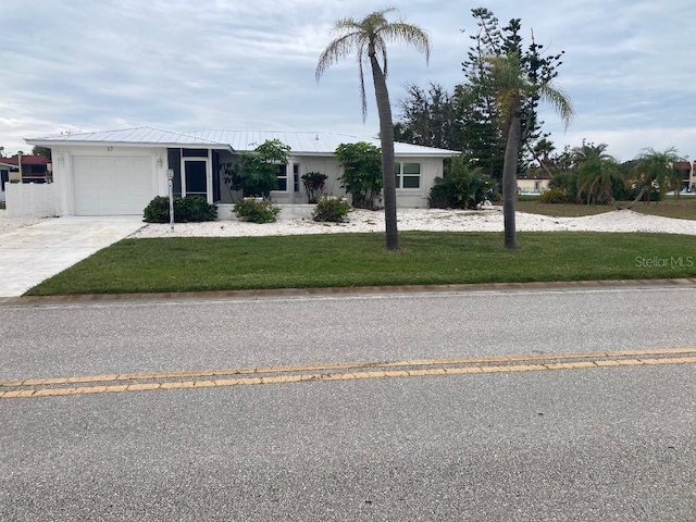 87 Rotonda Cir, Rotonda West, FL 33947 - ranch-style house featuring a garage, driveway, and a front yard
