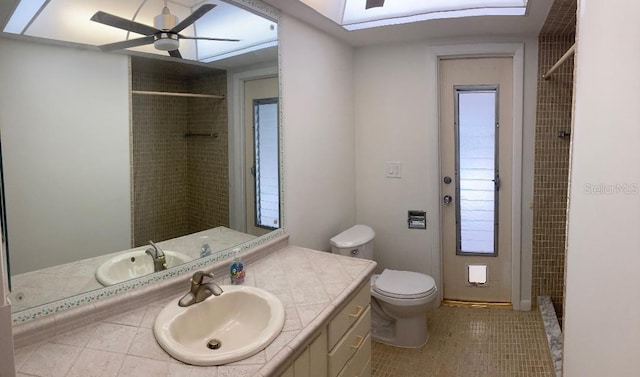 bathroom with a shower, tile patterned flooring, vanity, and toilet