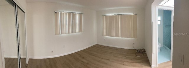 unfurnished bedroom featuring hardwood / wood-style floors and a closet